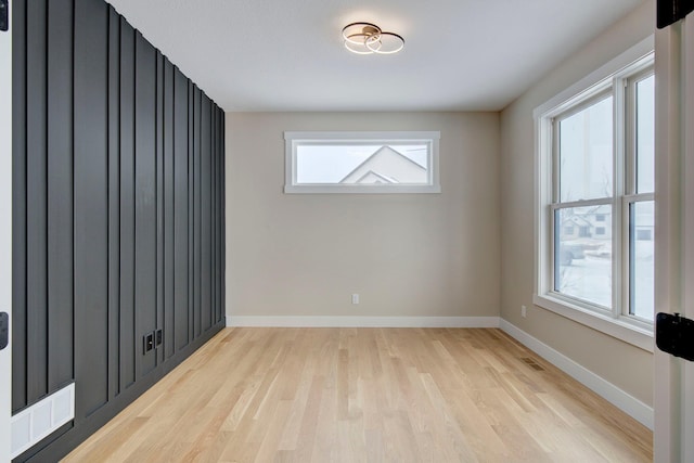 empty room featuring a wealth of natural light and light hardwood / wood-style floors