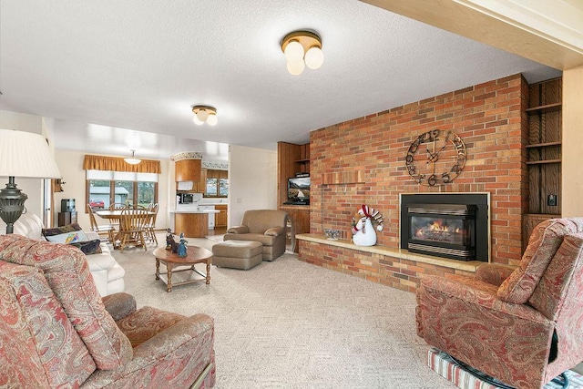 carpeted living room with a brick fireplace, brick wall, and a textured ceiling