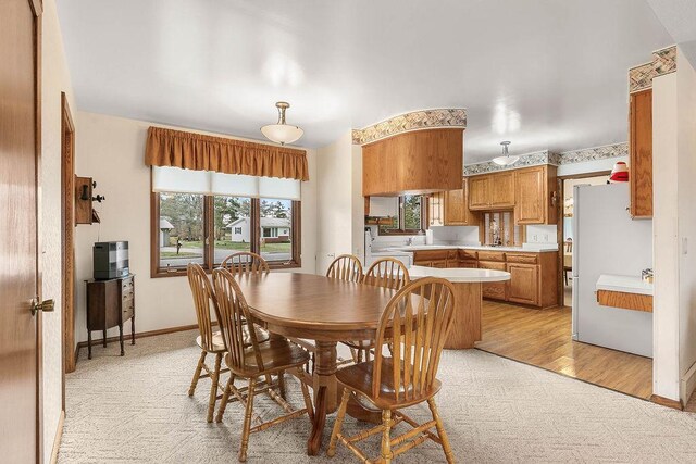 dining space with light colored carpet