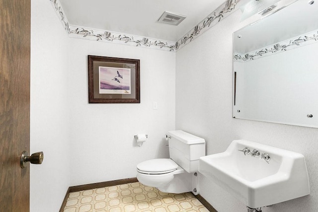 bathroom with tile patterned floors, toilet, and sink