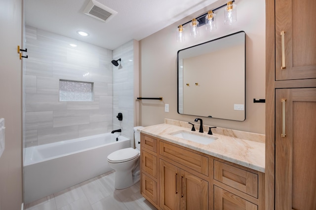 full bathroom featuring toilet, tiled shower / bath combo, and vanity