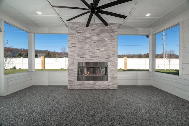 unfurnished sunroom with ceiling fan