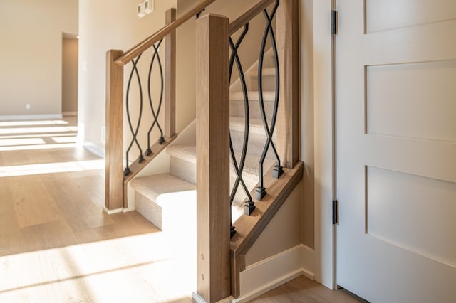 stairway featuring hardwood / wood-style flooring