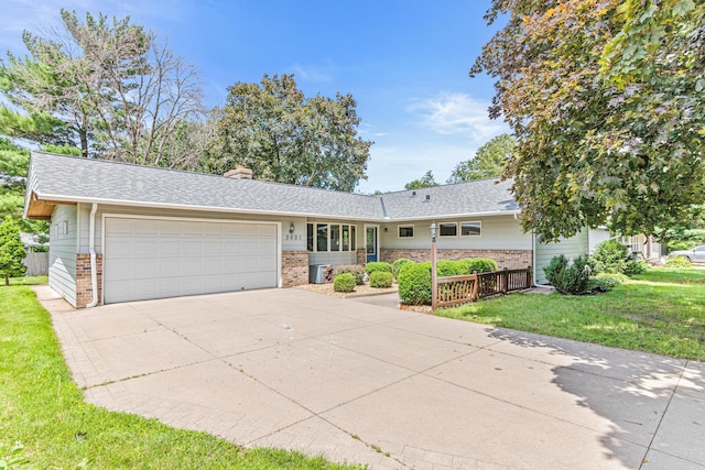 ranch-style house with a garage and a front yard