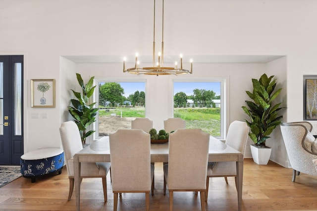 dining room featuring hardwood / wood-style floors, plenty of natural light, and a notable chandelier