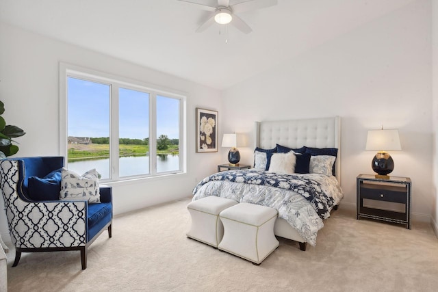 carpeted bedroom featuring ceiling fan, a water view, and lofted ceiling