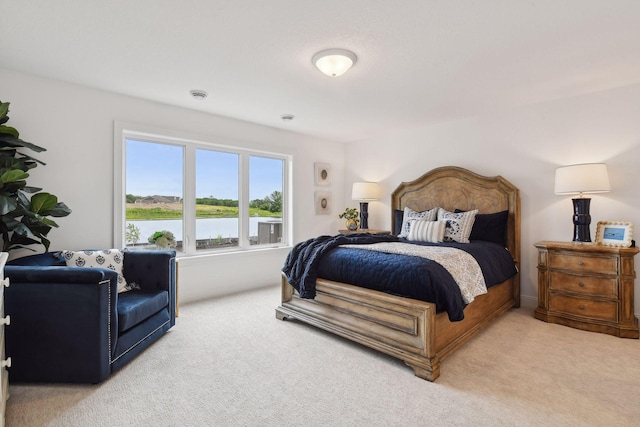 carpeted bedroom featuring a water view