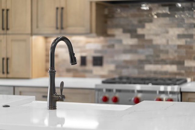 interior details featuring light stone countertops and light brown cabinetry