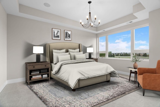 bedroom with a raised ceiling, carpet flooring, and an inviting chandelier