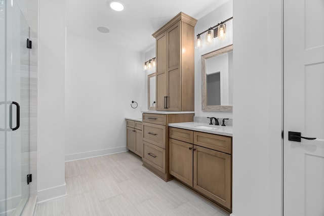 bathroom with tile patterned floors, vanity, and a shower with door