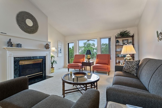 carpeted living room featuring a fireplace and high vaulted ceiling