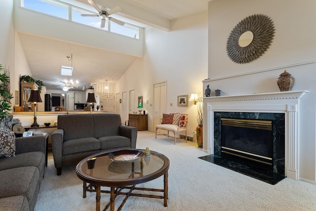 carpeted living room featuring high vaulted ceiling, a high end fireplace, ceiling fan, and beamed ceiling