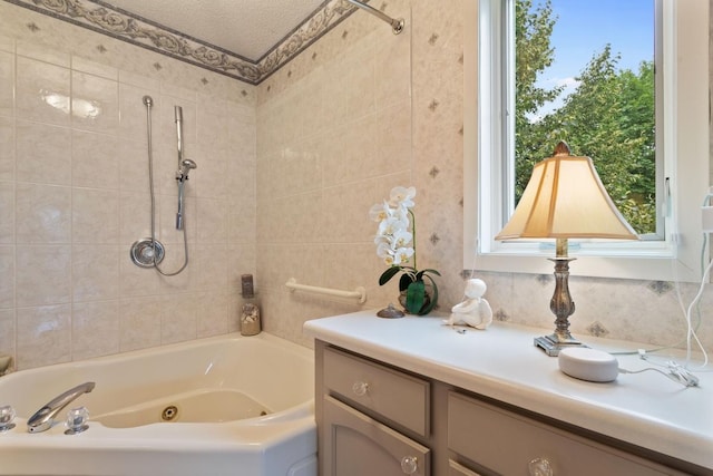 bathroom featuring a textured ceiling, vanity, and plus walk in shower