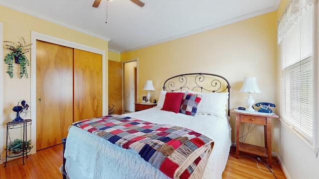 4200 Overlook Dr, Bloomington, MN 55437 - bedroom featuring wood finished floors, multiple windows, ornamental molding, a closet, and ceiling fan