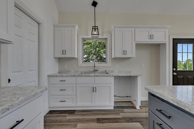 kitchen with sink, pendant lighting, dark hardwood / wood-style flooring, and white cabinets