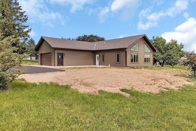 rear view of property with a garage