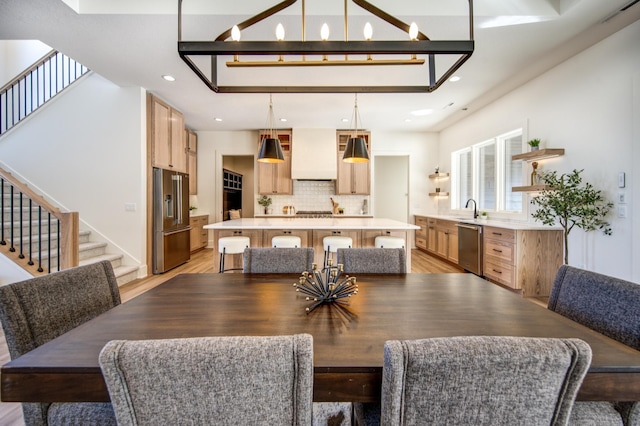 dining space featuring stairs, light wood-type flooring, and recessed lighting