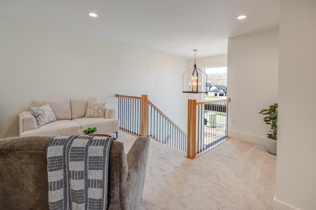 carpeted living room with a chandelier and recessed lighting