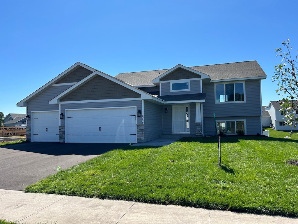 view of front of house with a front yard and a garage