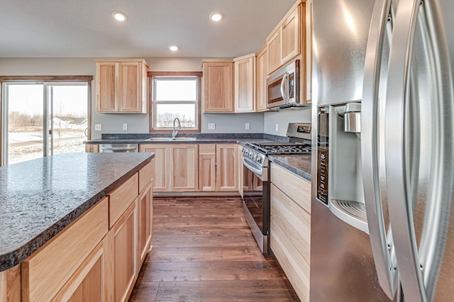 kitchen featuring a kitchen island, sink, dark hardwood / wood-style flooring, stainless steel appliances, and light brown cabinets