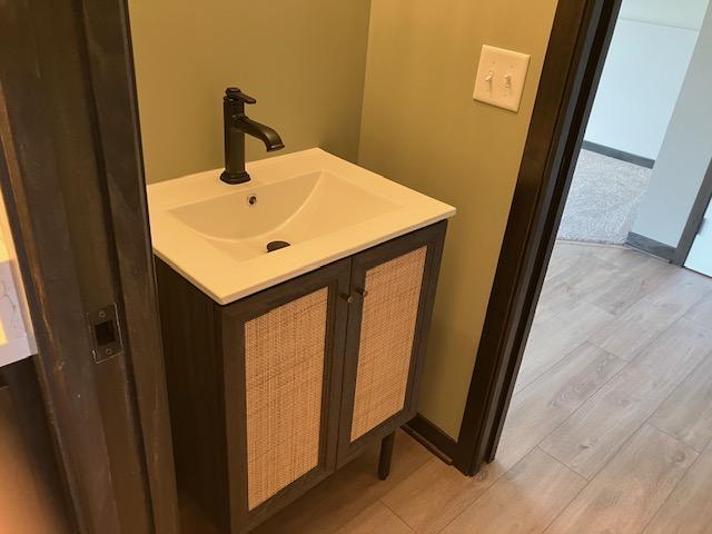 bathroom with hardwood / wood-style flooring and sink