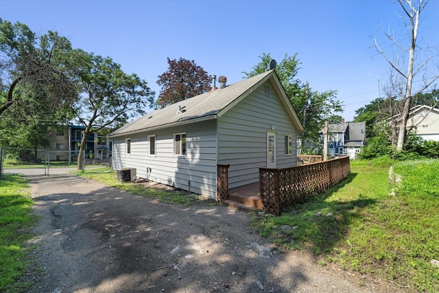 view of side of property with a deck and central AC unit