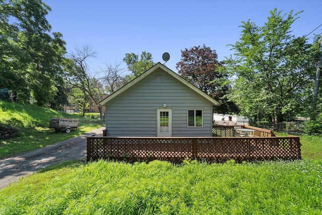 view of home's exterior featuring a wooden deck and a yard