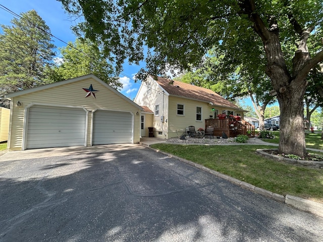 625 10th St, Montevideo, MN 56265 - view of front of property with an outdoor structure, a detached garage, and a deck