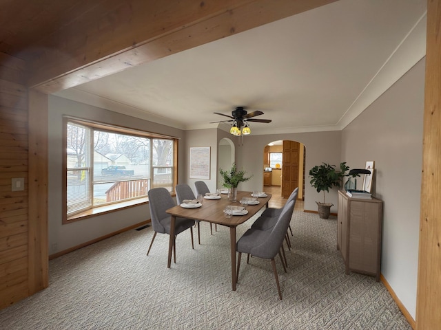 625 10th St, Montevideo, MN 56265 - dining area with arched walkways, light carpet, a ceiling fan, and baseboards