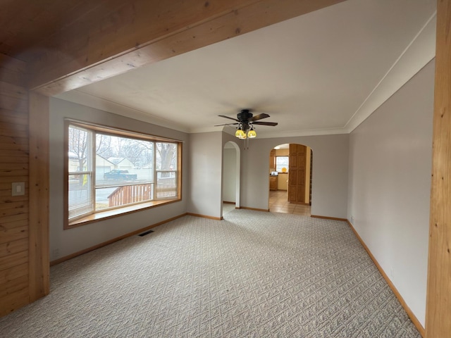625 10th St, Montevideo, MN 56265 - empty room featuring arched walkways, visible vents, carpet floors, and baseboards