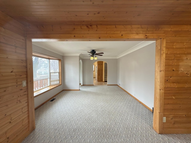 625 10th St, Montevideo, MN 56265 - carpeted empty room featuring arched walkways, crown molding, visible vents, and baseboards