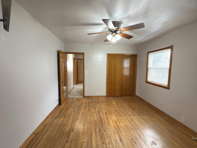 625 10th St, Montevideo, MN 56265 - unfurnished bedroom featuring light wood-style flooring, baseboards, a closet, and ceiling fan