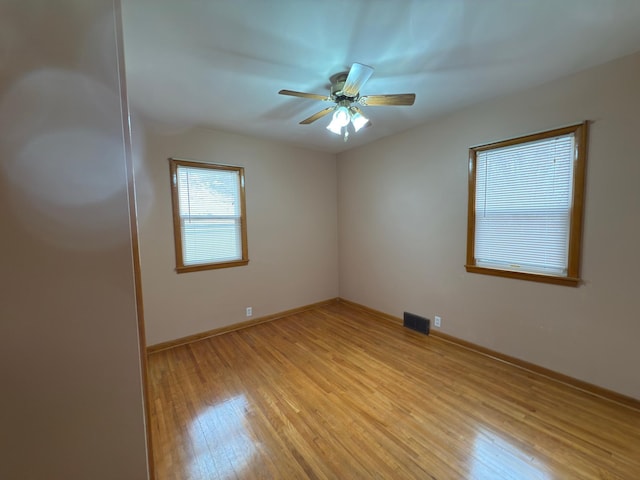 625 10th St, Montevideo, MN 56265 - unfurnished room with baseboards, light wood-style flooring, visible vents, and a ceiling fan
