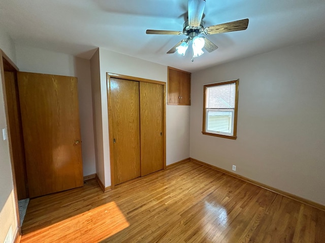 625 10th St, Montevideo, MN 56265 - unfurnished bedroom with light wood-style flooring, a closet, a ceiling fan, and baseboards