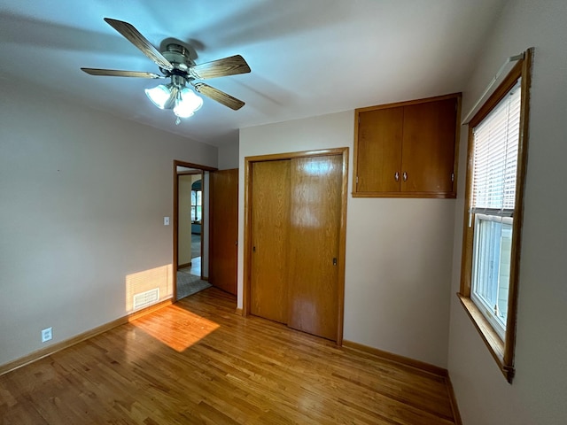 625 10th St, Montevideo, MN 56265 - unfurnished bedroom with baseboards, light wood-style flooring, visible vents, and a closet