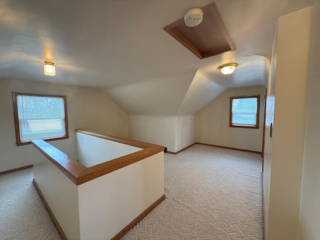 625 10th St, Montevideo, MN 56265 - additional living space with baseboards, lofted ceiling, and light colored carpet