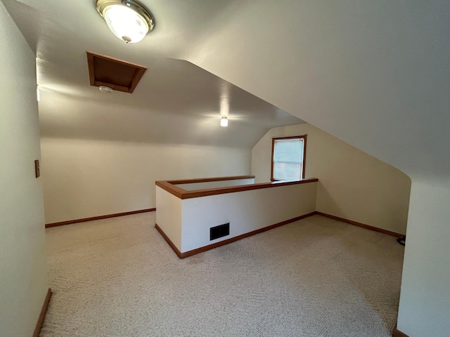 625 10th St, Montevideo, MN 56265 - additional living space with vaulted ceiling, baseboards, and carpet floors