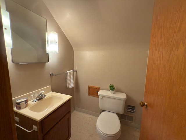 625 10th St, Montevideo, MN 56265 - bathroom with vaulted ceiling, toilet, and vanity