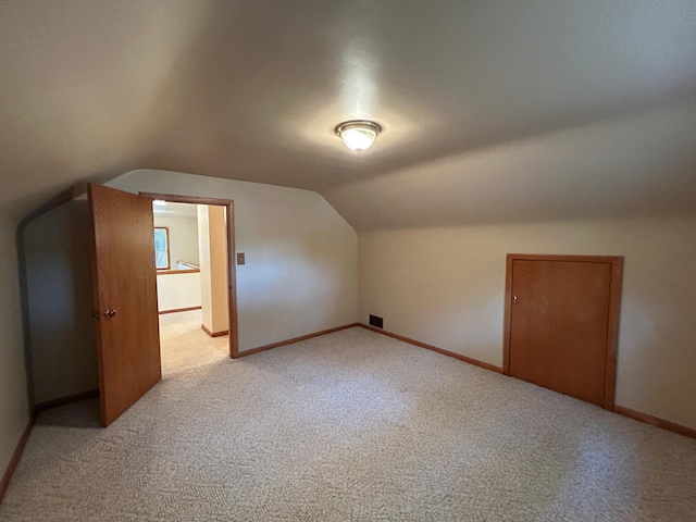 625 10th St, Montevideo, MN 56265 - additional living space featuring light colored carpet, lofted ceiling, visible vents, and baseboards