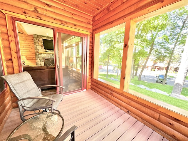 sunroom with a stone fireplace