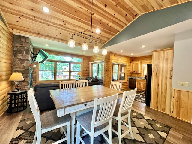 dining room featuring rustic walls, light hardwood / wood-style flooring, high vaulted ceiling, and wood ceiling