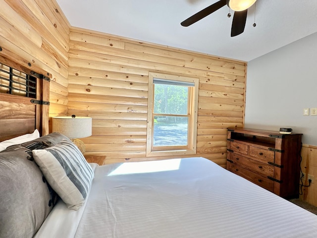 bedroom with rustic walls and ceiling fan