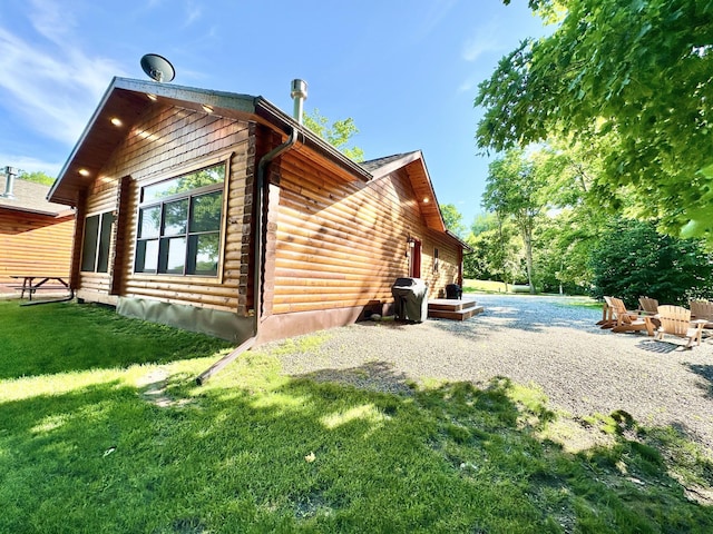 view of side of property with a lawn