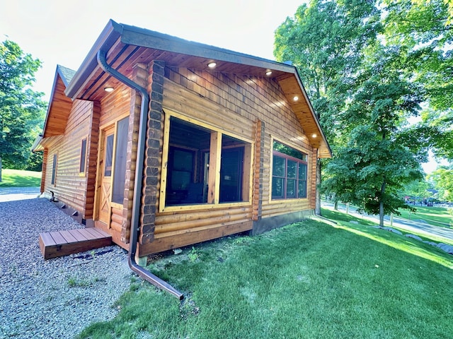 view of property exterior with a lawn