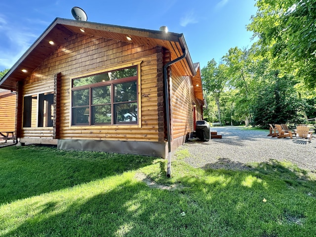 view of home's exterior with a yard and a patio