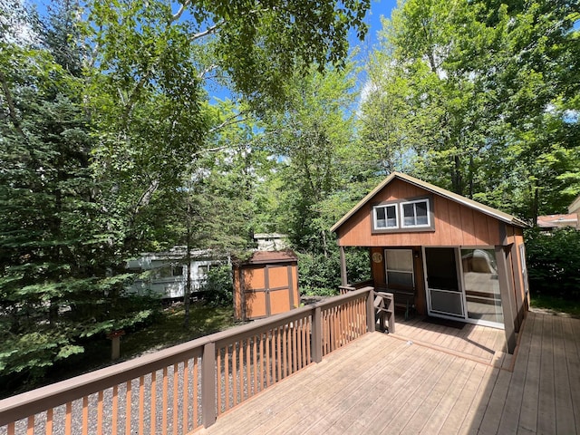 wooden deck featuring a storage unit