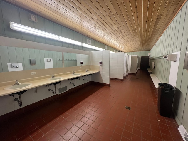 bathroom with wooden ceiling, tile patterned floors, and double sink vanity