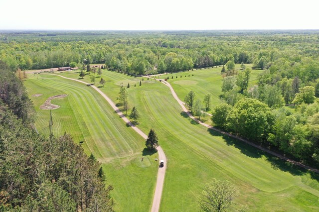 drone / aerial view with a wooded view