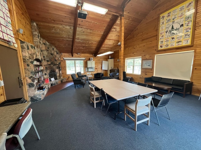 carpeted dining area with wood walls, high vaulted ceiling, wooden ceiling, and plenty of natural light