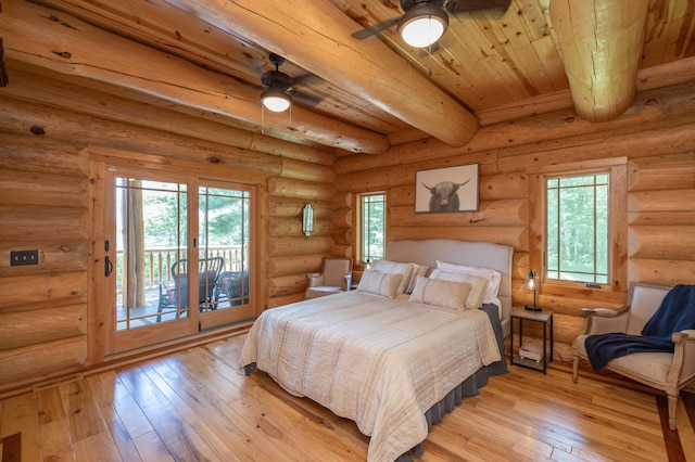 bedroom with ceiling fan, wood ceiling, log walls, and beamed ceiling